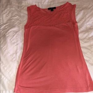 Sleeveless coral top with lace detailed neckline